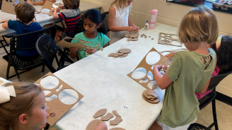 Tom Sykes children crafting during a summer camp.
