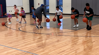 Children at basketball clinic in the gym.