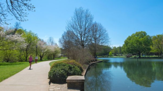 Person running on path near the lake at Freedom Park