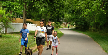 Family walking dog on the greenway.