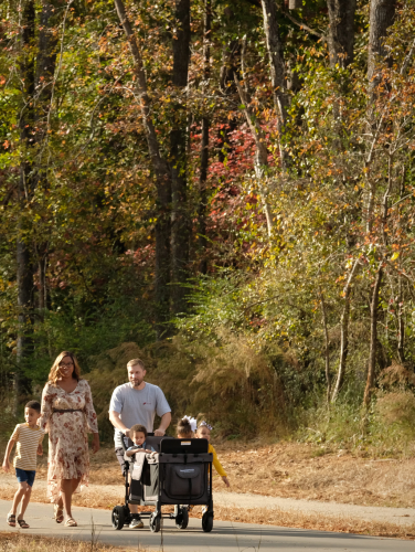 A group of people walking on a paved part of the Stevens Creek trail
