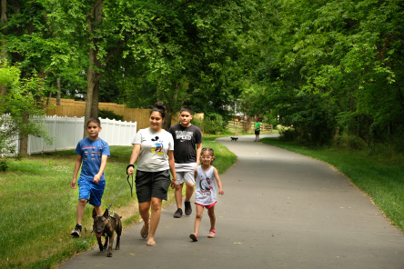 Family walking dog on the greenway.